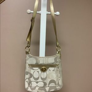 Coach Signature Crossbody bag with gold strap.